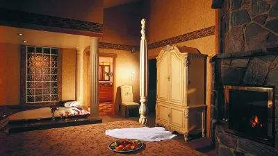 Chatea room fireplace, bed with tray of berries on bed